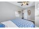 Bedroom with blue fish bedding, ceiling fan and a door leading to another room at 6327 Emerson S Ave, St Petersburg, FL 33707