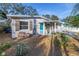 Charming bungalow with a teal door, landscaping, and a white picket fence at 6327 Emerson S Ave, St Petersburg, FL 33707