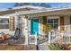 Quaint front entrance with a teal door and white picket fence at 6327 Emerson S Ave, St Petersburg, FL 33707