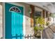 Close-up of teal front door and wooden shutters at 6327 Emerson S Ave, St Petersburg, FL 33707