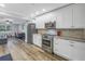 Modern kitchen with stainless steel appliances and white shaker cabinets at 6327 Emerson S Ave, St Petersburg, FL 33707