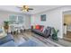 Living room with gray sofa and a small dining area at 6327 Emerson S Ave, St Petersburg, FL 33707