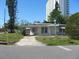 White single-story home with a flat roof and overgrown yard at 6701 Hibiscus S Ave, South Pasadena, FL 33707