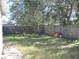 Small backyard with wooden fence and unkempt grass at 6720 Hibiscus S Ave, South Pasadena, FL 33707