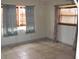 Simple bedroom with tile flooring and two windows at 6720 Hibiscus S Ave, South Pasadena, FL 33707