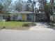 House exterior featuring a yellow door and a driveway at 6720 Hibiscus S Ave, South Pasadena, FL 33707