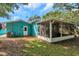 Screened patio with teal house exterior at 717 Carolina Ave, Tarpon Springs, FL 34689