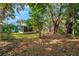 Large backyard with mature trees and grassy area at 717 Carolina Ave, Tarpon Springs, FL 34689