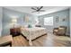 Bright bedroom with king bed, ceiling fan, and sitting chair at 717 Carolina Ave, Tarpon Springs, FL 34689