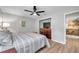 Main bedroom with ceiling fan and dresser, view of kitchen at 717 Carolina Ave, Tarpon Springs, FL 34689