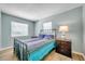 Bedroom with teal patterned bedspread and wood floors at 717 Carolina Ave, Tarpon Springs, FL 34689