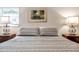 Main bedroom with gray bedding and wood nightstands at 717 Carolina Ave, Tarpon Springs, FL 34689