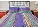 Bedroom with a purple and teal patterned bedspread at 717 Carolina Ave, Tarpon Springs, FL 34689