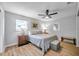 Main bedroom with ceiling fan and gray bedding at 717 Carolina Ave, Tarpon Springs, FL 34689