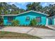 Teal house exterior with well-maintained landscaping at 717 Carolina Ave, Tarpon Springs, FL 34689