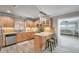 Open concept kitchen with island and view into living room at 717 Carolina Ave, Tarpon Springs, FL 34689