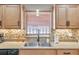 Kitchen sink and countertop detail with tile backsplash at 717 Carolina Ave, Tarpon Springs, FL 34689