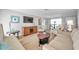 Living area with light-colored furniture and hardwood floors at 717 Carolina Ave, Tarpon Springs, FL 34689