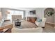 Bright living room with light beige furniture and wood floors at 717 Carolina Ave, Tarpon Springs, FL 34689