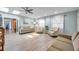 Spacious living room featuring hardwood floors and a view into the kitchen at 717 Carolina Ave, Tarpon Springs, FL 34689