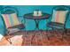 Small patio with metal table and chairs, colorful pillows at 717 Carolina Ave, Tarpon Springs, FL 34689