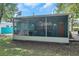 Screened porch with table and chairs at 717 Carolina Ave, Tarpon Springs, FL 34689