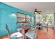 Screened porch with seating area and terracotta tile floor at 717 Carolina Ave, Tarpon Springs, FL 34689