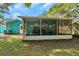 Large screened porch with ceiling fan at 717 Carolina Ave, Tarpon Springs, FL 34689