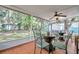 Relaxing screened porch with outdoor seating and ceiling fan at 717 Carolina Ave, Tarpon Springs, FL 34689