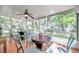 Relaxing screened porch with outdoor seating and ceiling fan at 717 Carolina Ave, Tarpon Springs, FL 34689