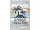 Metal wall art featuring palm trees and beach-themed text at 717 Carolina Ave, Tarpon Springs, FL 34689