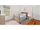 Cozy bedroom with wood bed frame, carpeted floors, and window at 732 Ocean Spray Dr, Ruskin, FL 33570