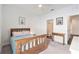 Light and airy bedroom with wood bed frame and access to bathroom at 732 Ocean Spray Dr, Ruskin, FL 33570