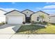 Single-story home with two-car garage and landscaped lawn at 732 Ocean Spray Dr, Ruskin, FL 33570