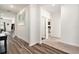 Light-filled hallway with wood-look floors and multiple doors at 732 Ocean Spray Dr, Ruskin, FL 33570