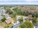 Aerial view of the home and surrounding neighborhood with a lake at 7436 Baltusrol Dr, New Port Richey, FL 34654