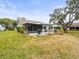 Landscaped backyard features a patio, screened porch and grassy area at 7436 Baltusrol Dr, New Port Richey, FL 34654