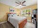 Cozy bedroom with a double bed, ceiling fan, and built-in shelving at 7436 Baltusrol Dr, New Port Richey, FL 34654