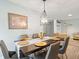 Elegant dining area featuring a dark wood table and gold accents at 7436 Baltusrol Dr, New Port Richey, FL 34654