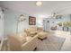 Living room with light beige leather furniture and a ceiling fan at 7436 Baltusrol Dr, New Port Richey, FL 34654