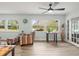 Living area with wood-look tile, built-in shelving, and French doors at 7436 Baltusrol Dr, New Port Richey, FL 34654