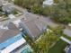 Aerial view of a two-story home with manicured landscaping, a pool, and a well-maintained roof at 7602 S Desoto St, Tampa, FL 33616