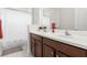 Bathroom with double vanity, white countertops, and a shower/tub combo at 7602 S Desoto St, Tampa, FL 33616