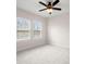 Well-lit bedroom featuring two windows and neutral carpet at 7602 S Desoto St, Tampa, FL 33616