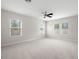 Large bedroom with three windows, ceiling fan, and neutral carpeting at 7602 S Desoto St, Tampa, FL 33616