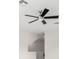 Close-up of a modern ceiling fan with sleek black blades against a neutral ceiling and walls at 7602 S Desoto St, Tampa, FL 33616