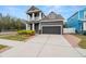 Two-story home with gray exterior and balcony at 7602 S Desoto St, Tampa, FL 33616