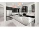 Modern kitchen featuring stainless steel appliances, granite countertops, dark cabinetry, and white tile backsplash at 7602 S Desoto St, Tampa, FL 33616