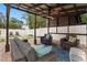 Covered patio with seating area, ceiling fan, and TV at 7602 S Desoto St, Tampa, FL 33616