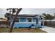 Side yard view of a light blue house with solar panels at 7623 Gulf Blvd, St Pete Beach, FL 33706